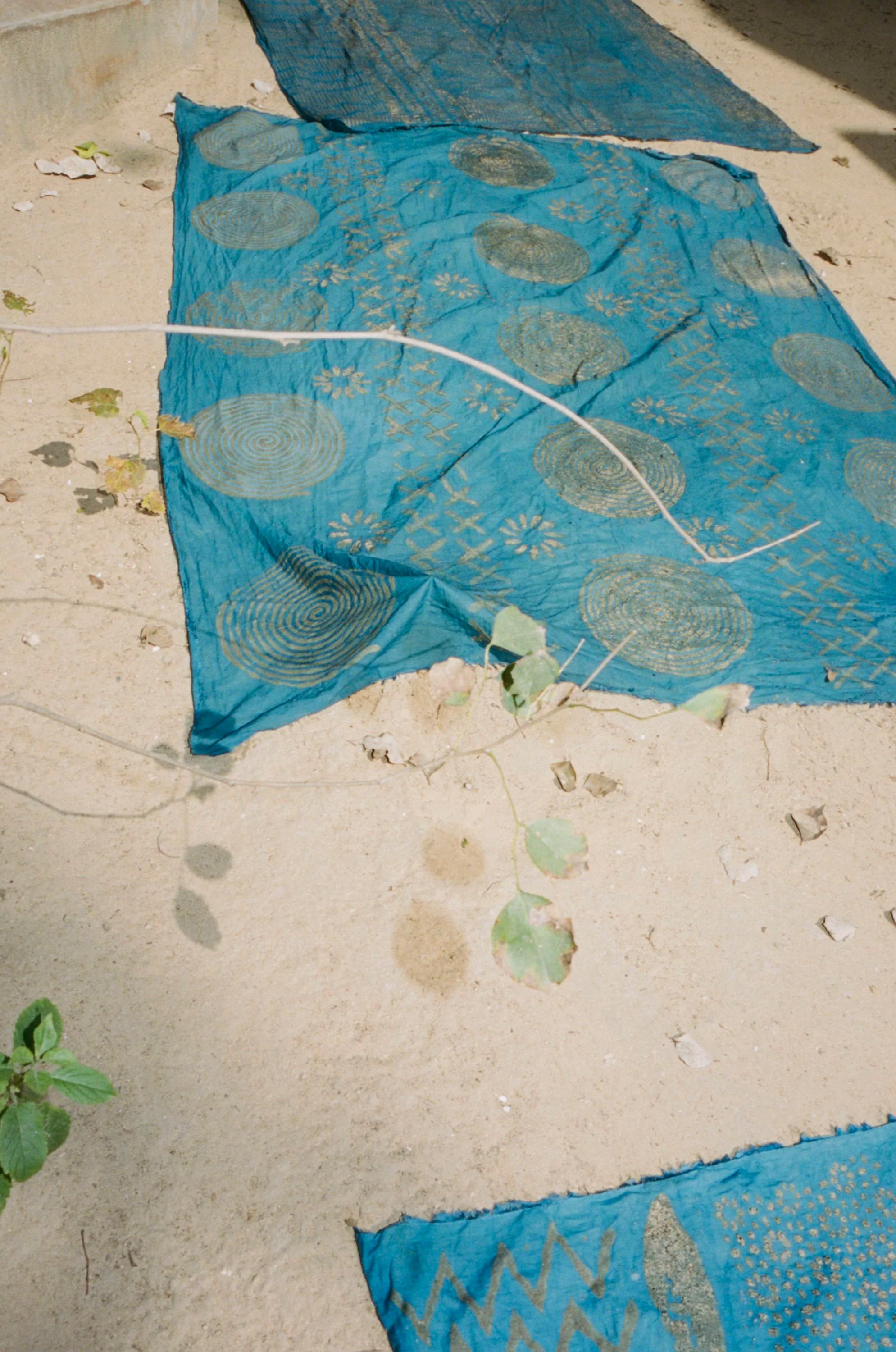 Block printed fabric drying on ground