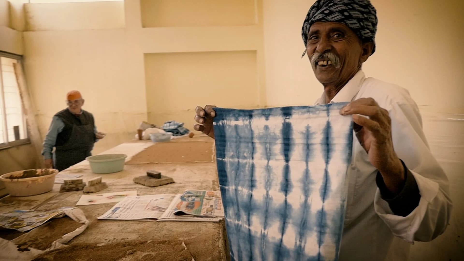 Artisan with shibori fabric display